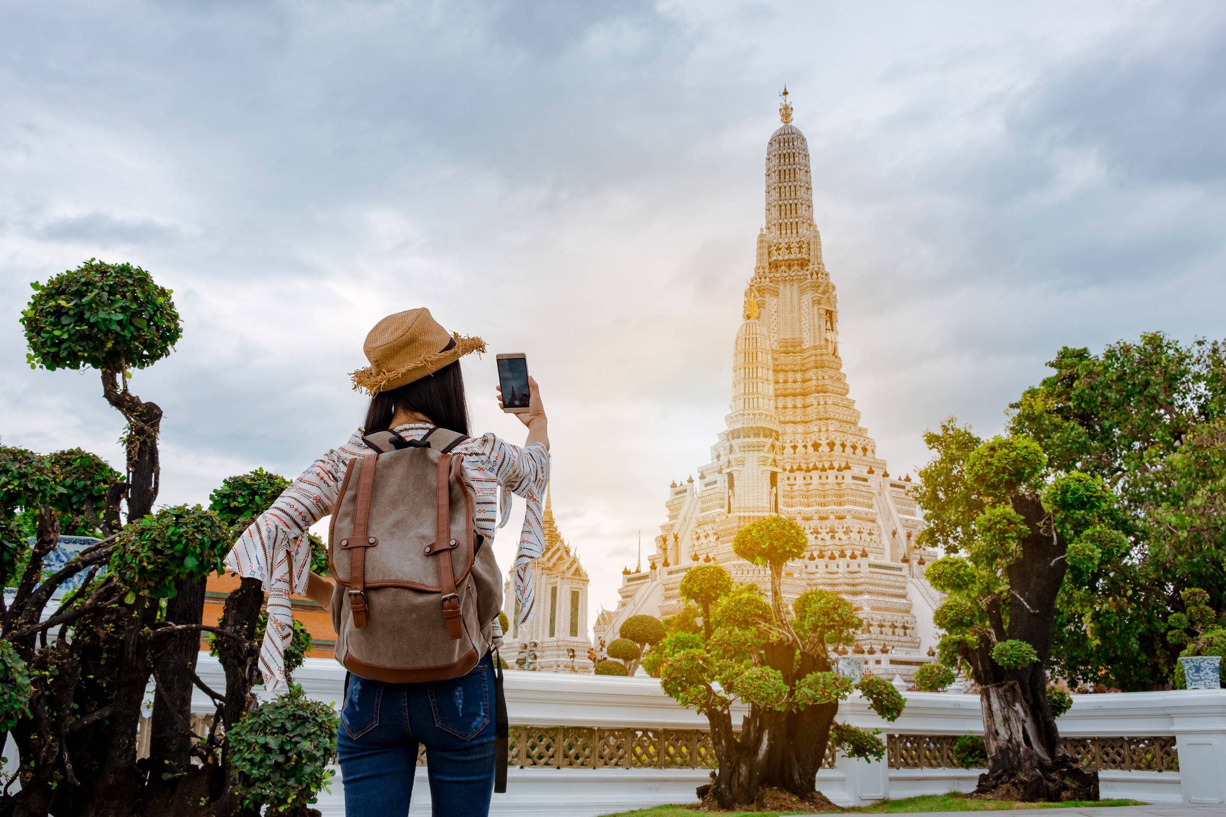 Asian Woman Tourists Are Taking Photos With A Smartphone At The Wat Arun Temple