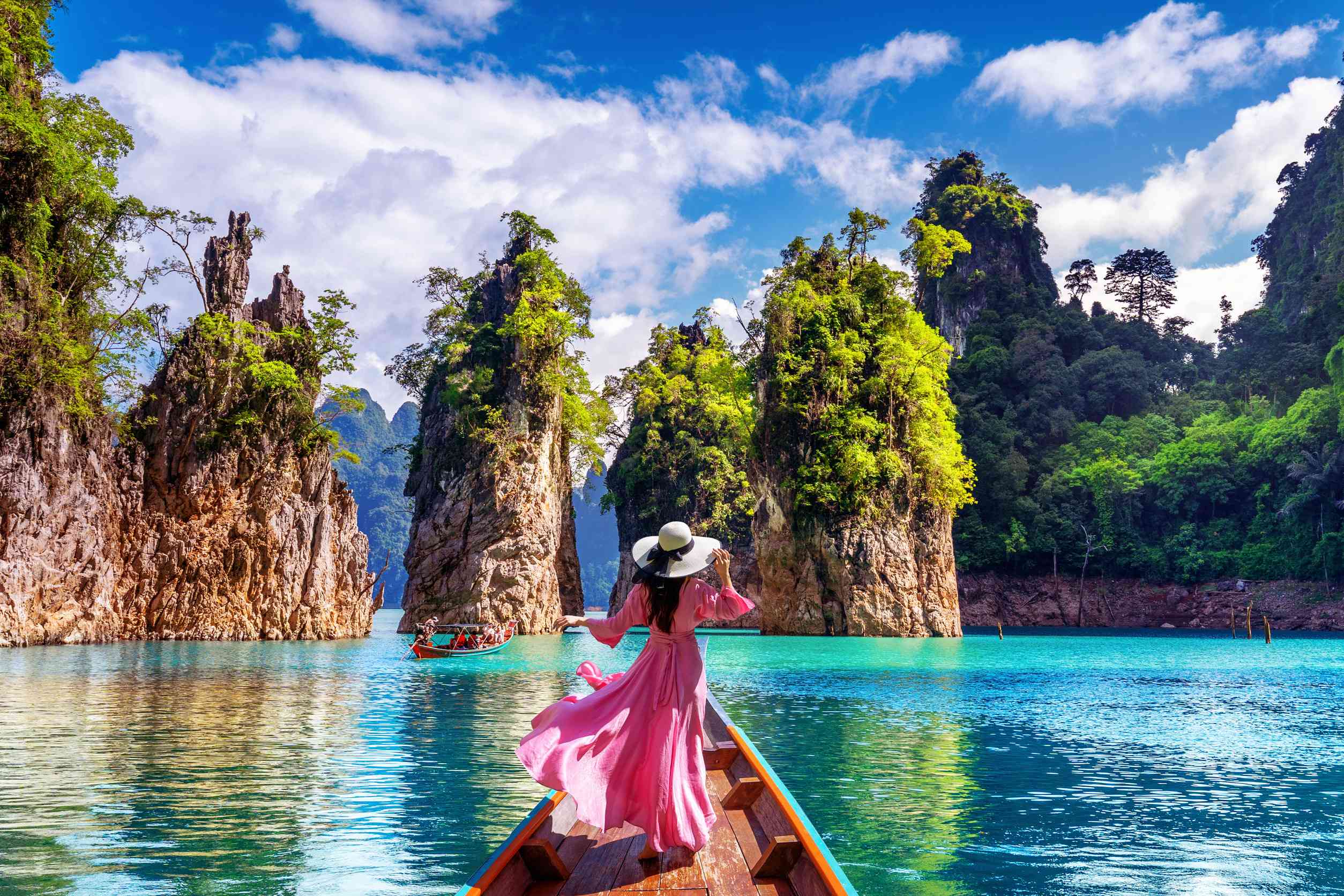 Beautiful Girl Standing On The Boat And Looking To Mountains In Ratchaprapha