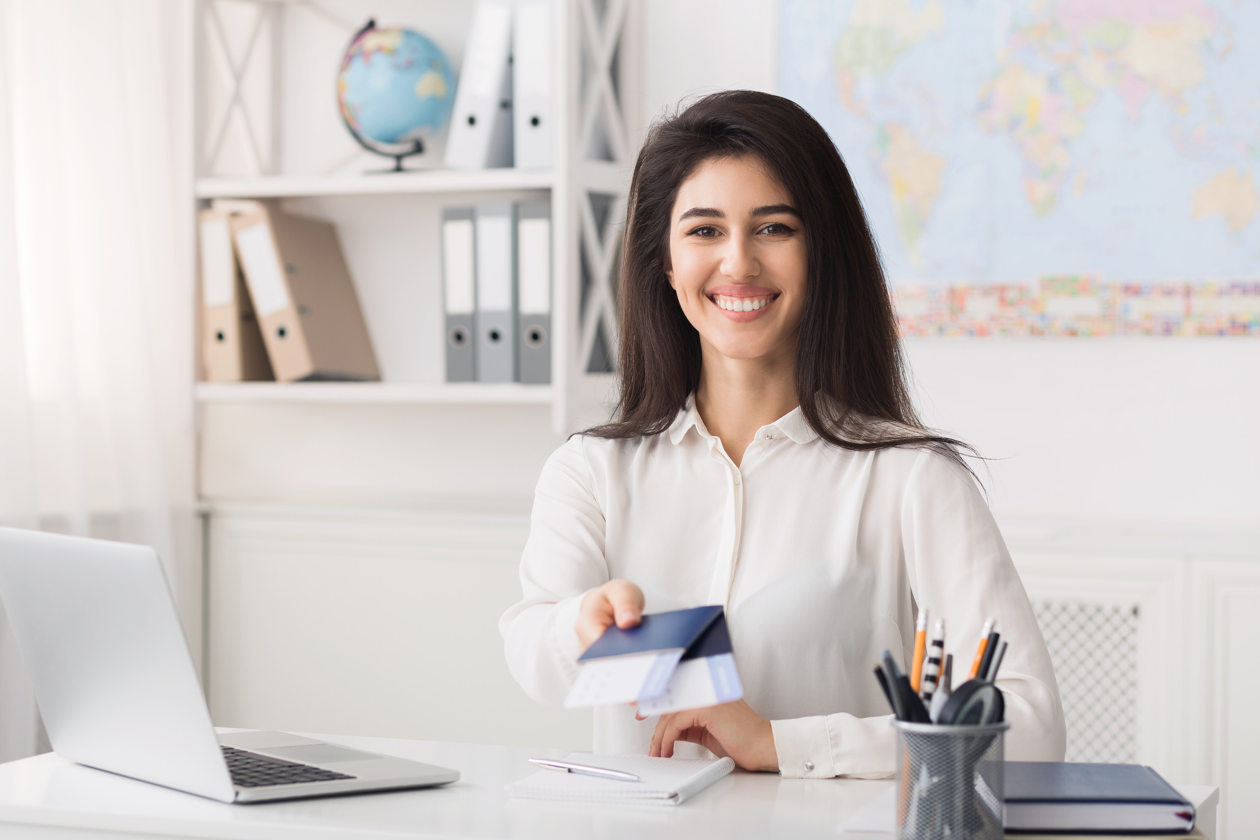 Female Travel Agent Giving Passports With Airline Tickets For Client Free Space