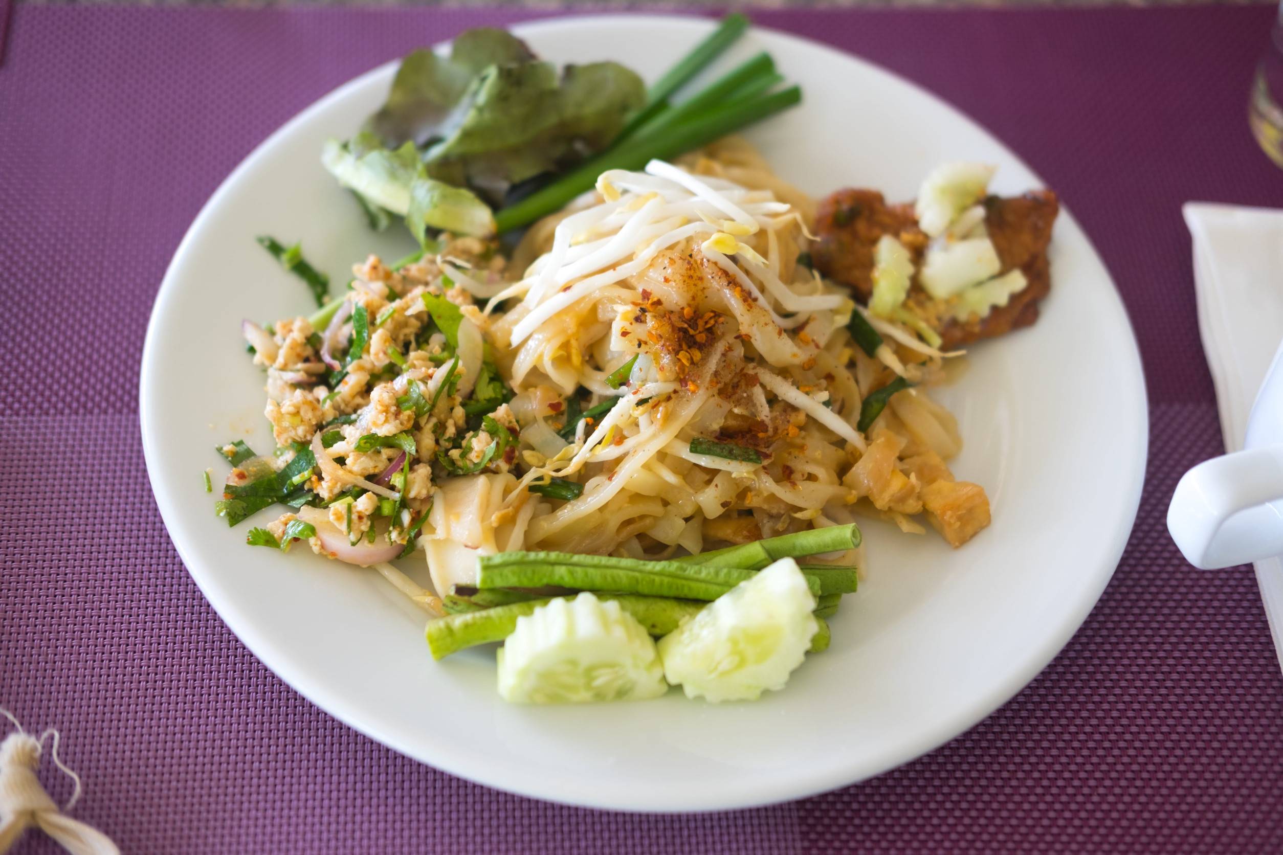 Thai Cuisine On A White Plate With Napkins On Its Side Thai Cuisine On A White Plate With Napkins On Its Side