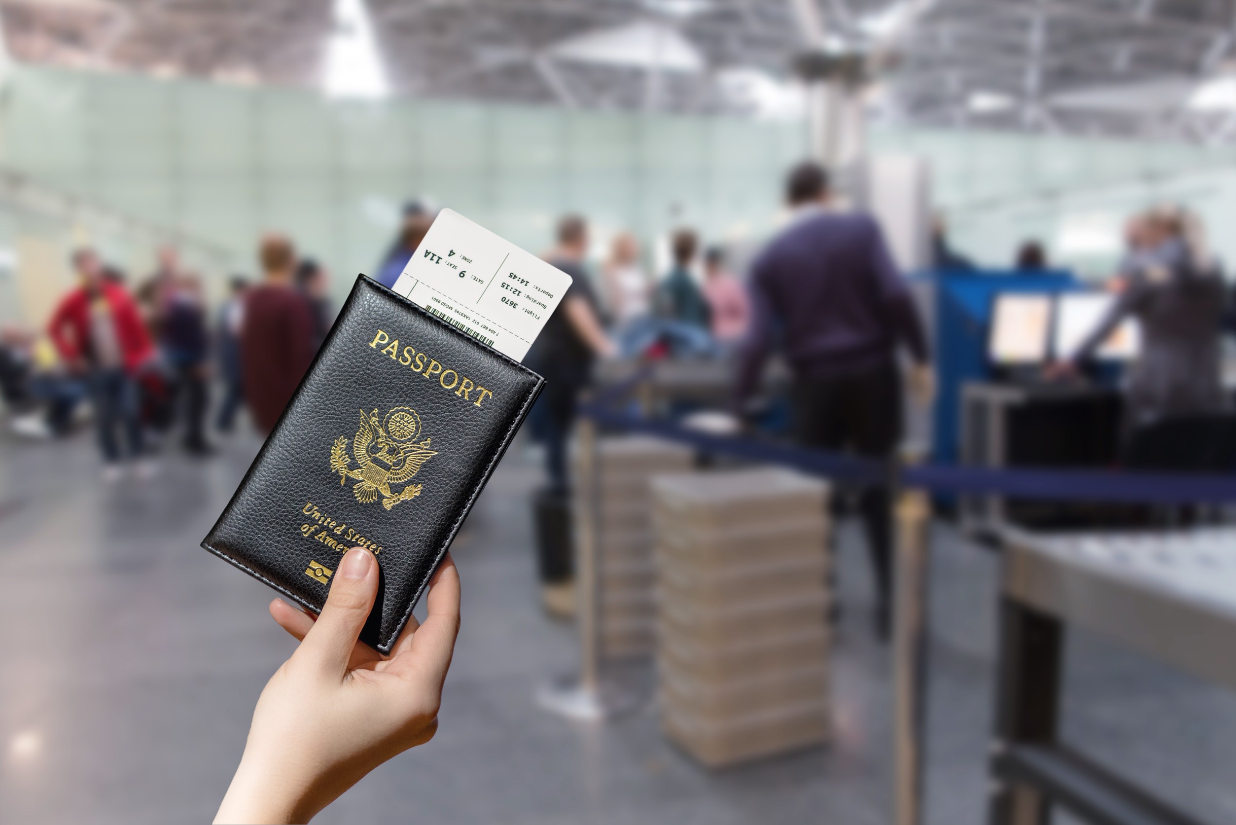 Woman Hand Holding American Passport With Boarding Pass In The Airport